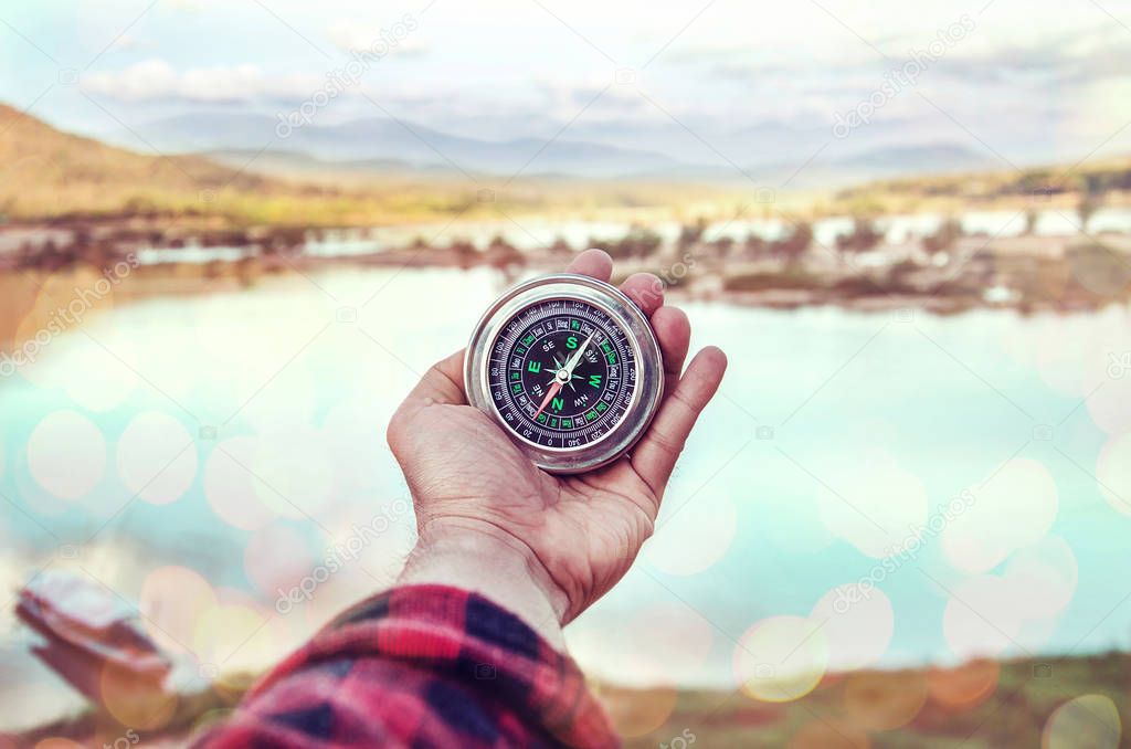 Hand of person holding compass