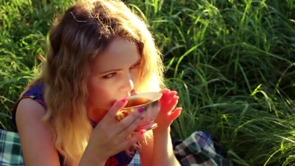 Young woman drinking hot tea — Stock Video
