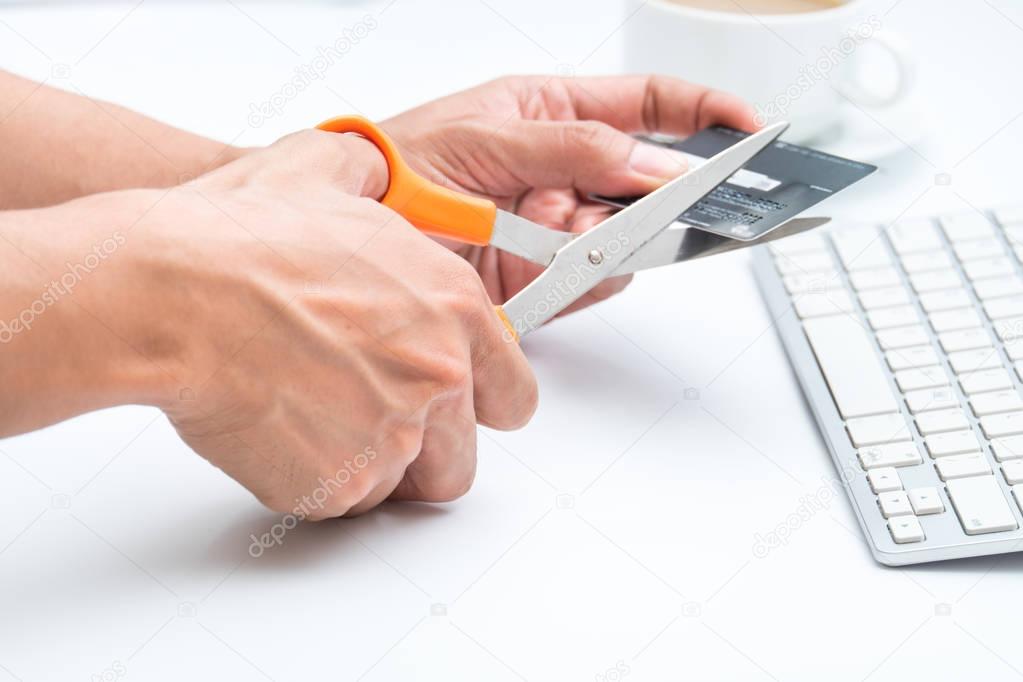 Cutting credit card on white background