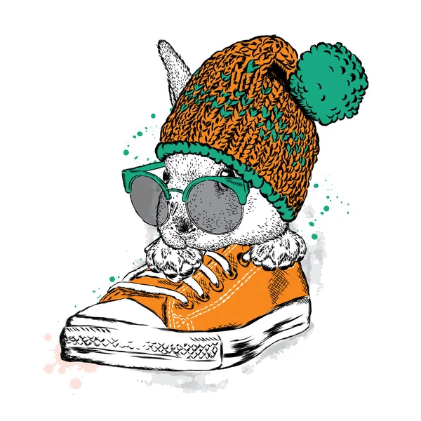 Cute rabbit with glasses and a hat with a bubo. Hare sitting in sneakers. Vector illustration for greeting card, poster, or print on clothes. Fashion & Style. — Stockový vektor