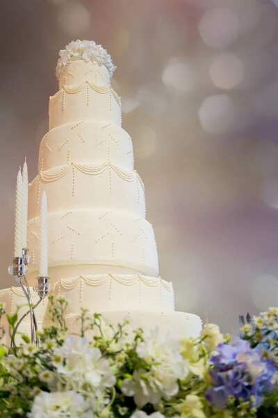 Decorated wedding cake in luxury ballroom