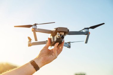 Remote controlled copter with digital camera in the hand. Closeup.