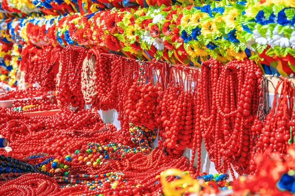 Gorgeous red and colorful beads. National Jewelry of Ukraine multicolored beads. Womens jewelry beads and flowers sold on the counter. Closeup
