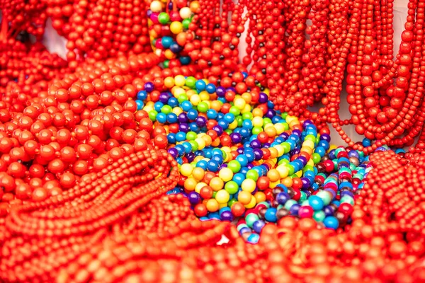 Gorgeous red and colorful beads. National Jewelry of Ukraine multicolored beads. Womens jewelry beads sold on the counter. Closeup. Abstract multicolored background,