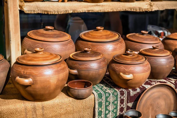 Clay dishes. Crockery made of clay. Ceramic national Ukrainian dishes made in the Poltava region in the village of Opishnya and demonstrated at the in Velyki Sorochyntsi Fair.