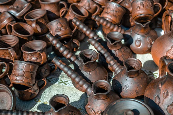 Clay dishes. Crockery made of clay. Ceramic national Ukrainian dishes made in the Poltava region in the village of Opishnya and demonstrated at the in Velyki Sorochyntsi Fair. Burnt black ceramics