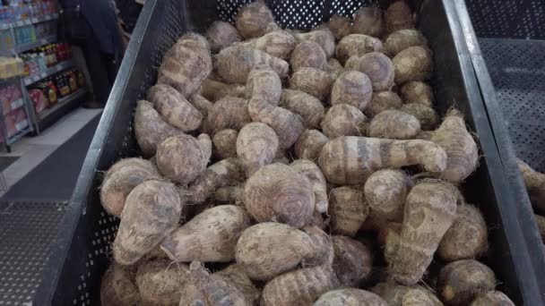 Pile of raw, unpeeled tropical Eddoes on a market stall in the UK — Stock Video