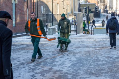 Council workers gritting the path clipart