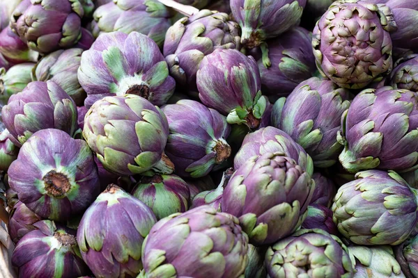 Pile of purple globe artichokes background image — Stock Photo, Image