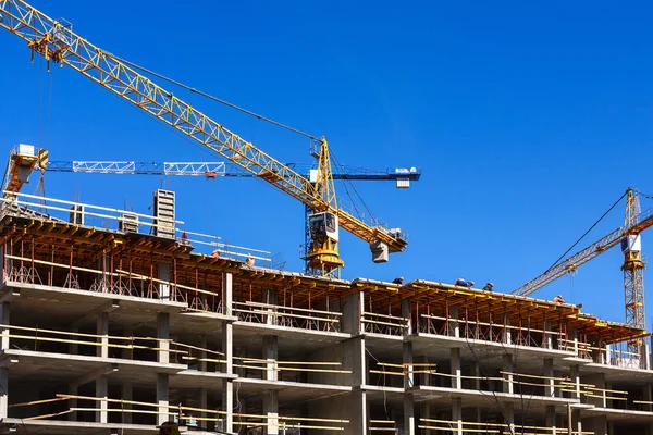 Construction of a multi-storey building on a blue sky background Stock Photo