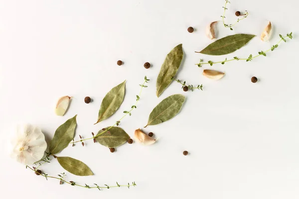 Flat lay. Food background, herbs, garlic and spices on white background.