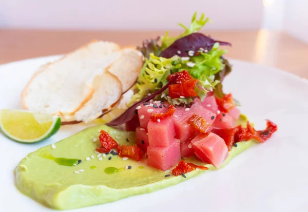 Tuna Tartar with avocado, lettuce, sun-dried tomatoes and bread chips — Stock Photo, Image