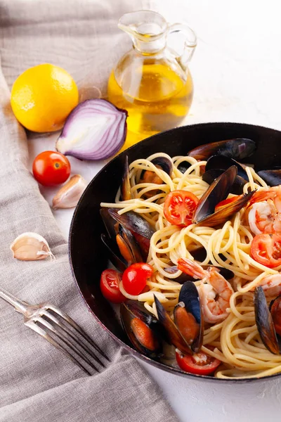 Seafood pasta. Spaghetti with mussels and tiger prawns, traditional pasta with shrimp close-up