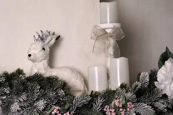 Cute little deer. Winter, Christmas, New Year decoration. Decorative deer -   interior, home decor. Christmas composition with figure of deer decorated for new year