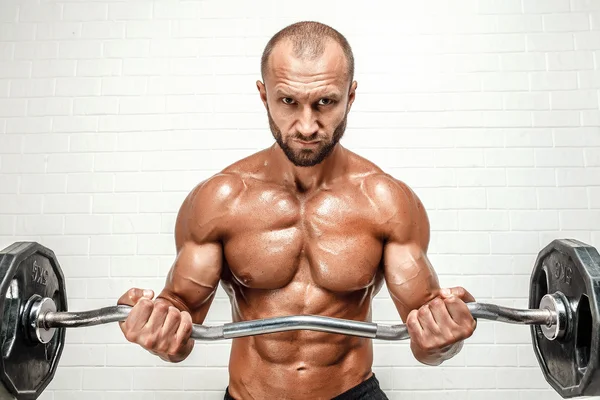 Strong man with weight bar — Stock Photo, Image