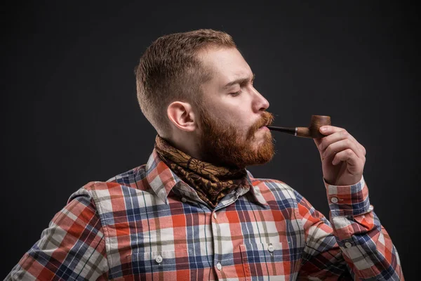 Homem barbudo elegante segurando cachimbo de fumar — Fotografia de Stock