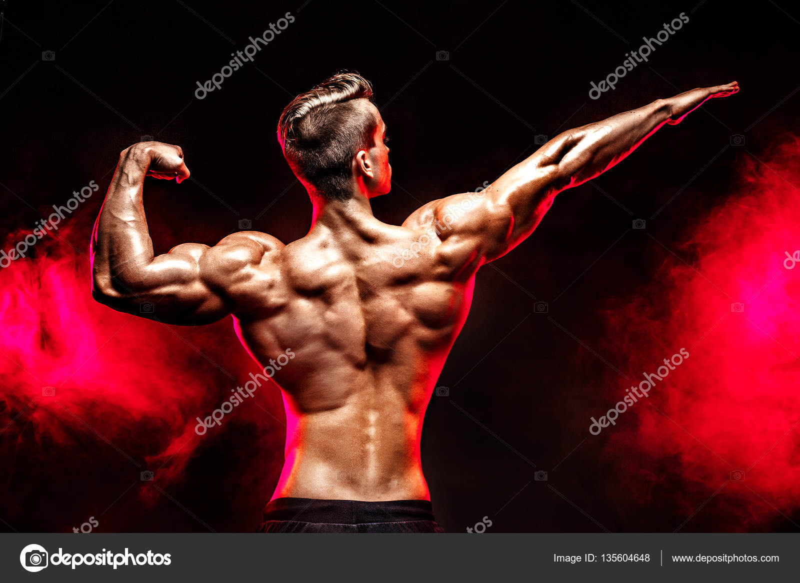 Back view of Unrecognizable man, strong muscles posing with arm up in