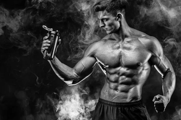 タンパク質と筋肉男は濃い煙をシェーカーで飲む — ストック写真