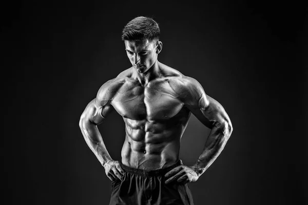 A testépítő pózol. Gyönyörű sportos férfi erő. Fitness izmos ember — Stock Fotó
