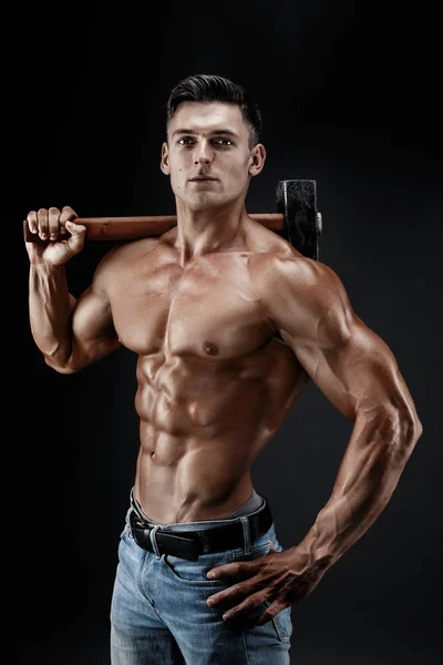 Muscular man with naked torso holding big hummer. Isolated on dark grey background — Stock Photo, Image