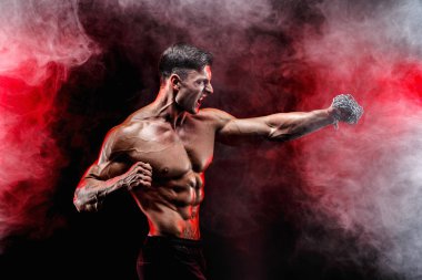 Yumruğunu üzerinde örgülü zincirlerle yumruk yaparken ciddi kas avcı.