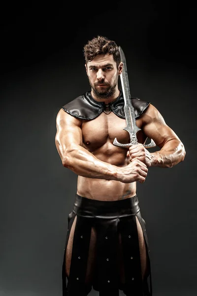 Kılıçlı, deri kostümlü bir barbar. — Stok fotoğraf