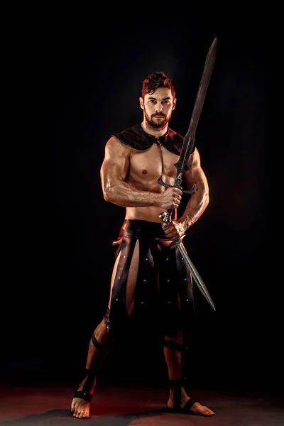 Severe barbarian in leather costume with sword