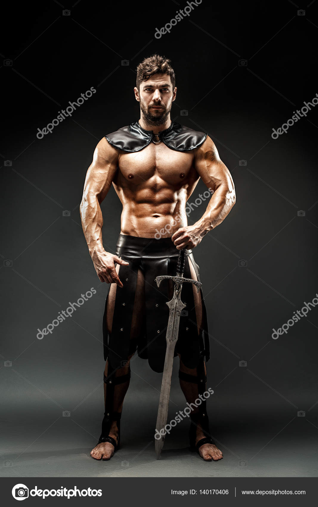 Severe barbarian in leather costume with sword Stock Photo by ©zamuruev  140170406
