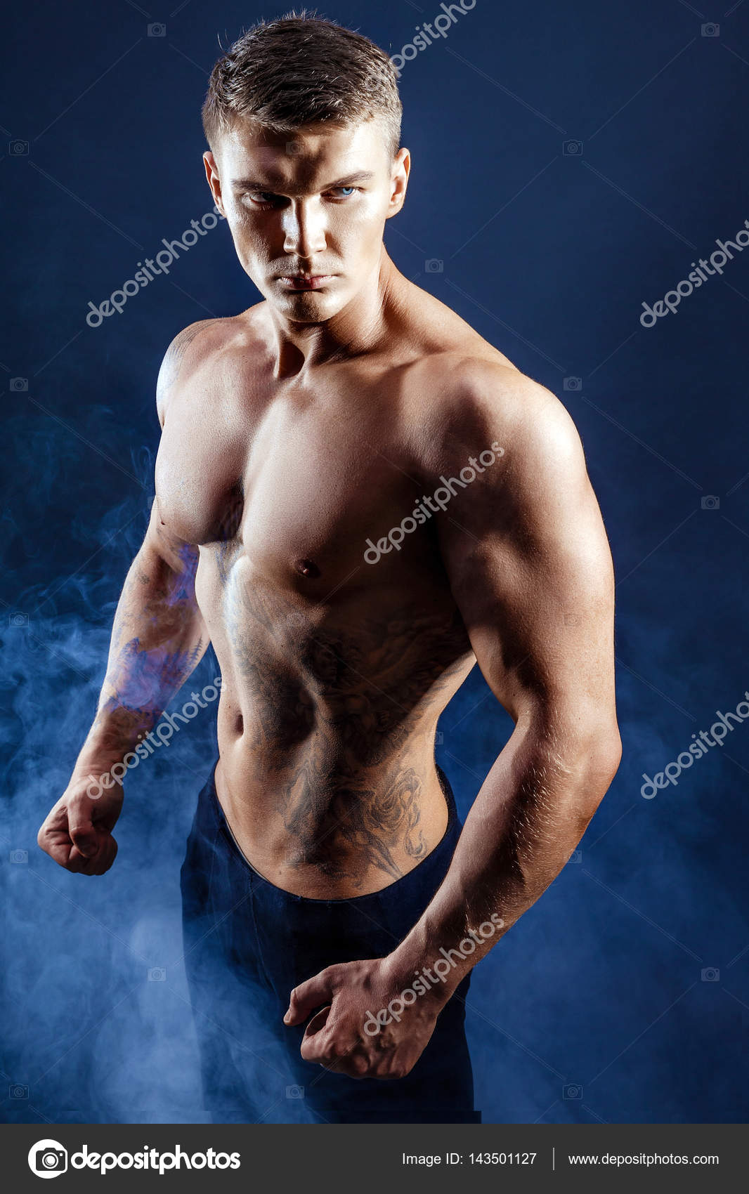Handsome power athletic man bodybuilder. Fitness muscular body on dark