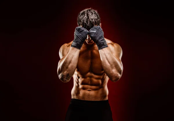 Strong muscular fighter hiding face from camera — Stock Photo, Image