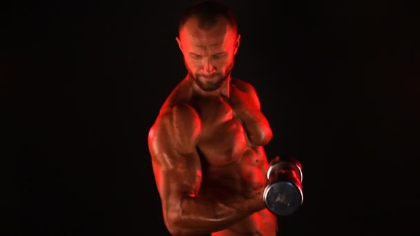 Strong sportsman lifting heavy dumbbell in smoke — Stock Video