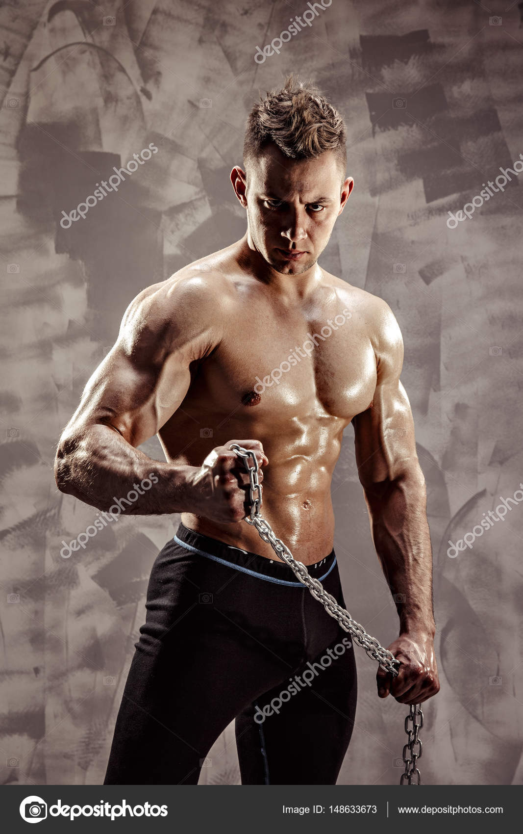 The Perfect male body - Awesome bodybuilder posing. Hold a chain with tattoo Stock Photo by ©zamuruev 148633673 The Perfect male body - Awesome bodybuilder posing. Hold a chain with tattoo Stock Photo by ©zamuruev 148633673