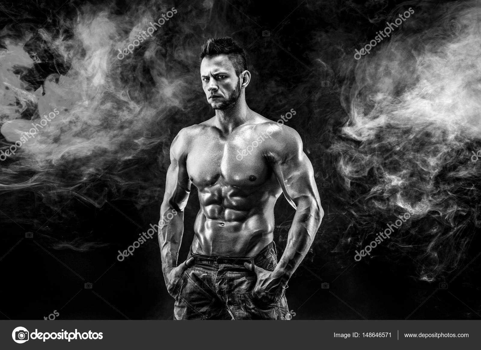 Strong bodybuilder man in military pants with perfect abs