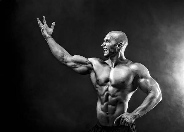 Bald handsome man, muscular topless body holding arm up with anger. Isolated. — Stock Photo, Image