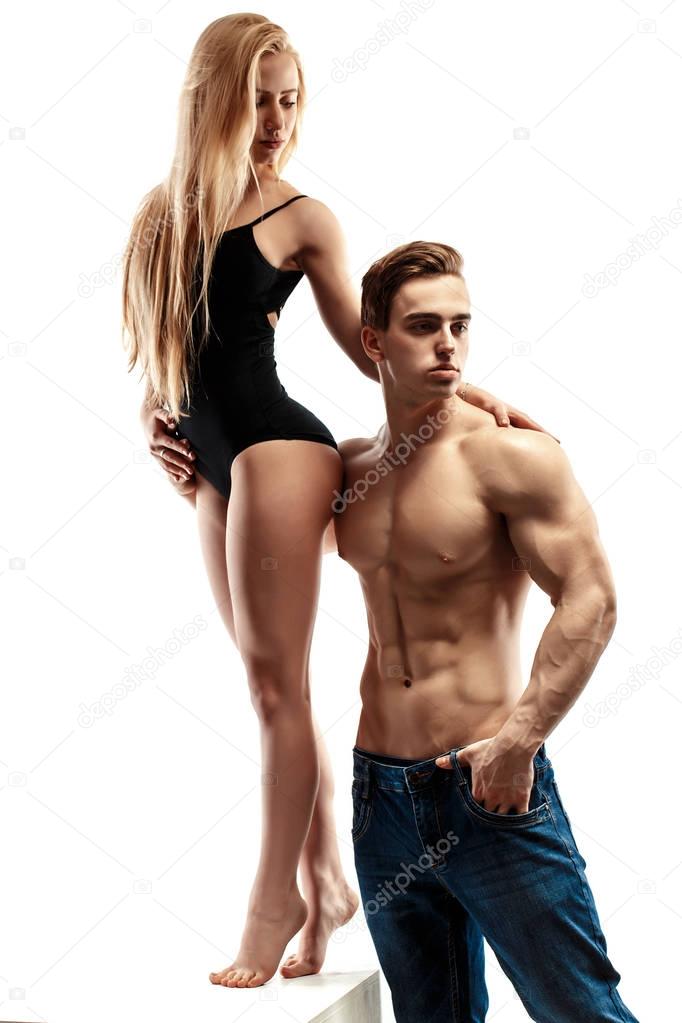 sexy couple, muscular man with a beautiful blonde woman isolated on a white background