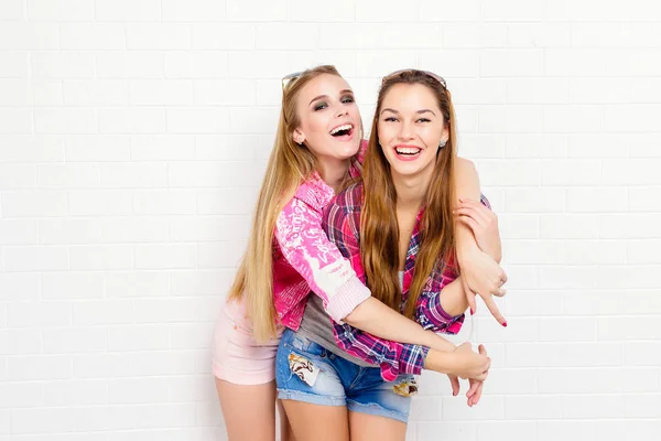 Fashion portrait of two friends posing. modern lifestyle.two stylish sexy hipster girls best friends ready for party.Two young girl friends standing together and having fun. Looking at camera. — Stock Photo, Image