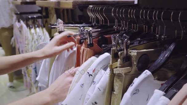 Fashionable woman choosing clothes — Stock Video