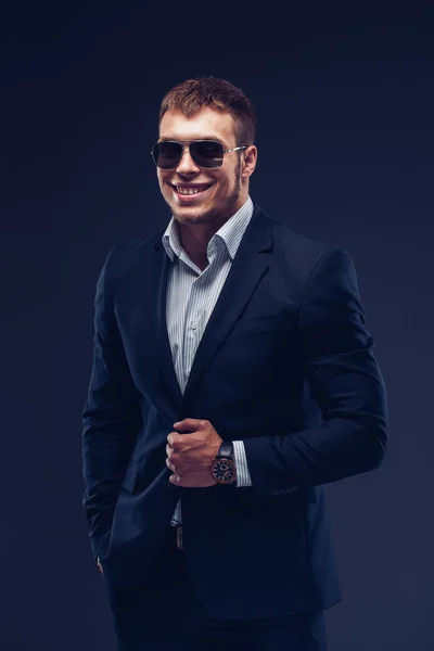 Fashion young businessman black suit on dark background — Stock Photo, Image