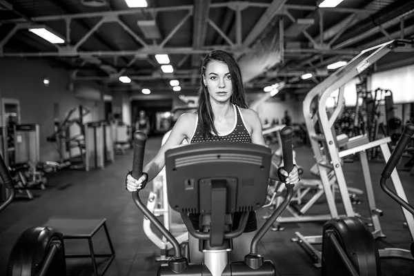 Jovem mulher fitness fazendo exercícios de cardio no ginásio correndo em uma esteira . — Fotografia de Stock