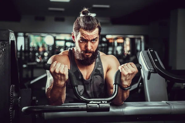Ember csinálás nehéz testsúly gyakorolja a bicepsz, a gép egy tornaterem — Stock Fotó