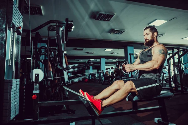 Stark Bodybuilder gör tung vikt övning för baksidan på maskin — Stockfoto