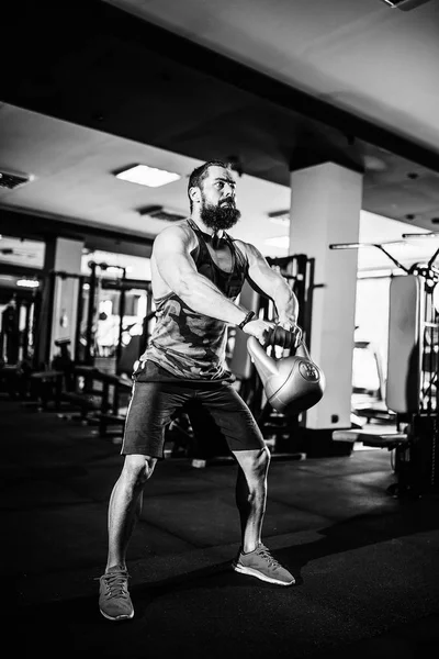 Fitness Kettlebells swing exercise man workout at gym