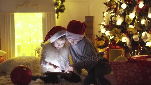 Ενθουσιασμένοι παιδιά κοντά στο χριστουγεννιάτικο δέντρο — Αρχείο Βίντεο
