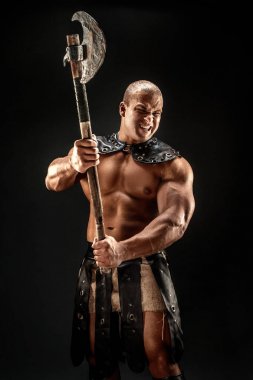 Severe barbarian in leather costume with hammer clipart