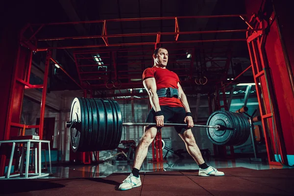 Muscular fitness man doing deadlift a barbell in modern fitness center. Functional training. — Stock Photo, Image