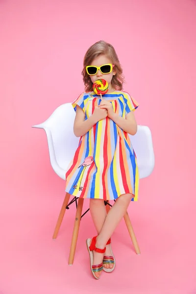 Cute girl in sunglasses with lollipop — Stock Photo, Image