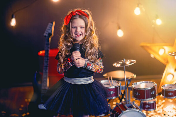 little beautiful girl singing in recording studio
