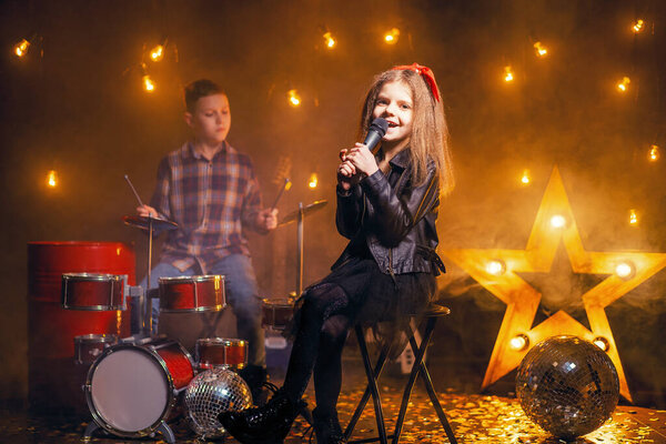 Kids pretending to be in a rock band