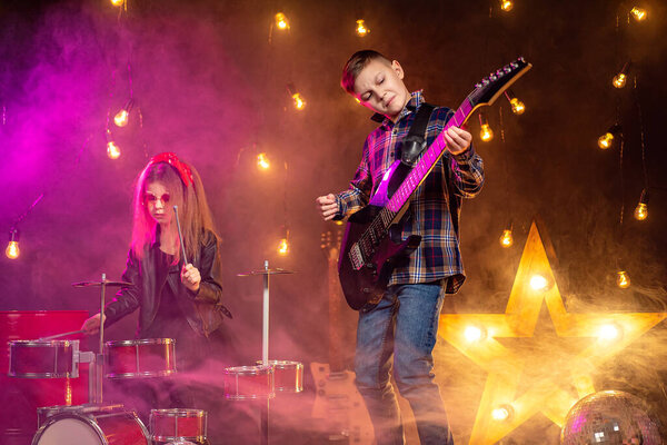 Kids pretending to be in a rock band