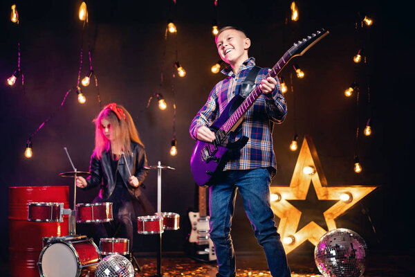 Kids pretending to be in a rock band